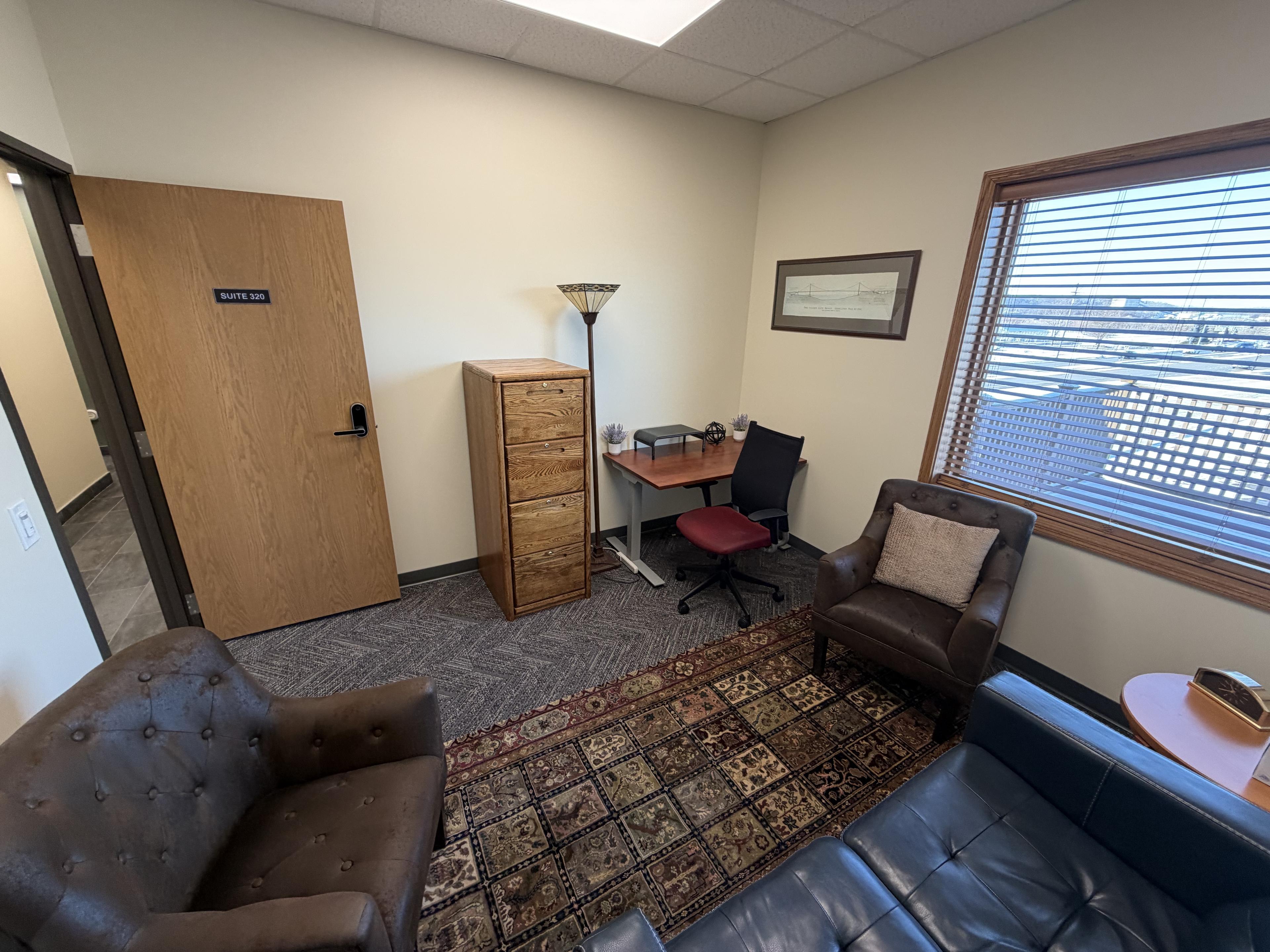 Suite 320 — entry door visible with file cabinet, desk, and seating inside the furnished office