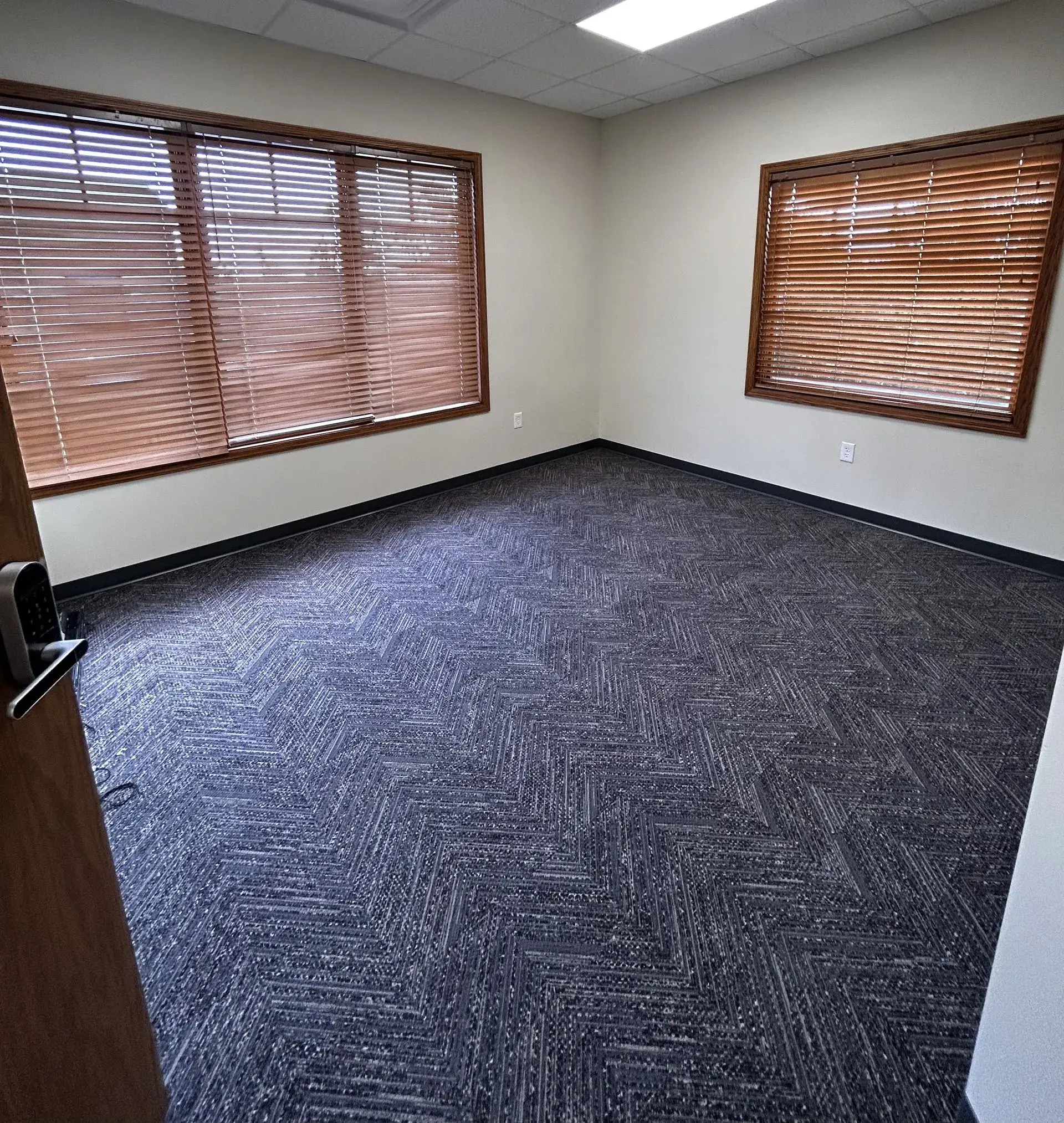 Unfurnished private office, white walls — bring your own setup